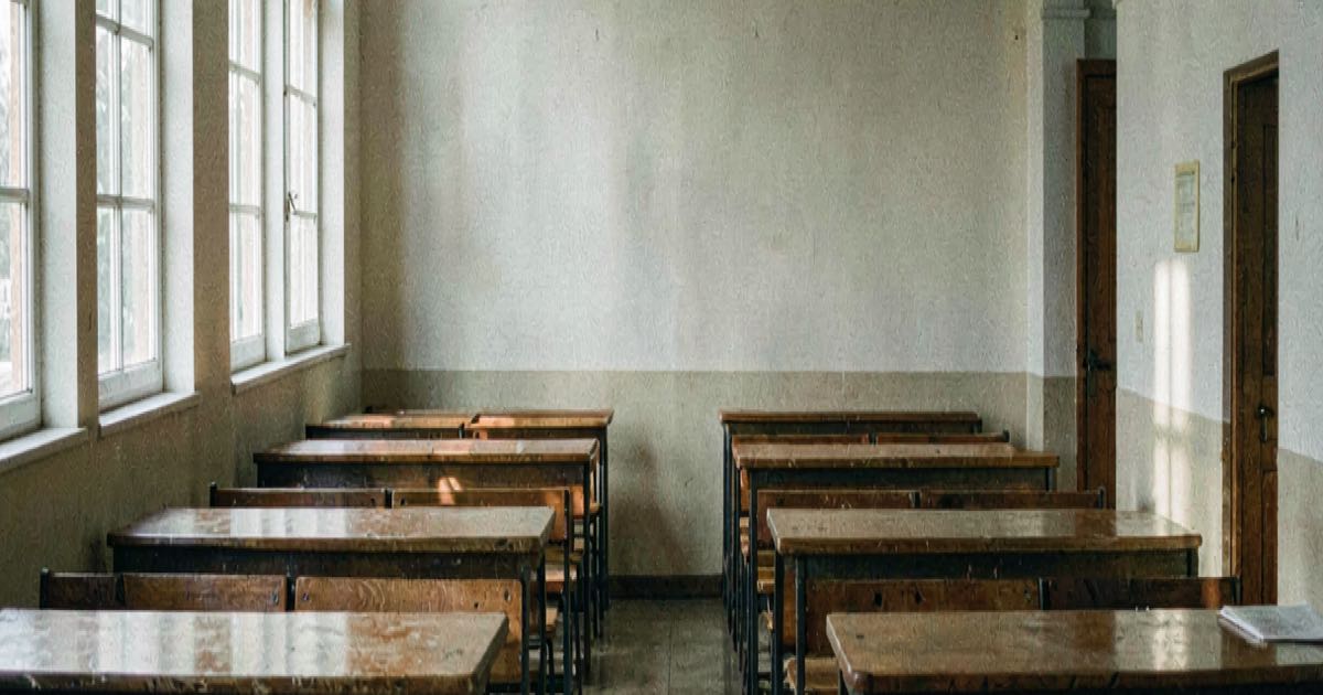 An empty university lecture hall with rows of desks and a clock on the wall, soft natural light through tall windows, documentary style.