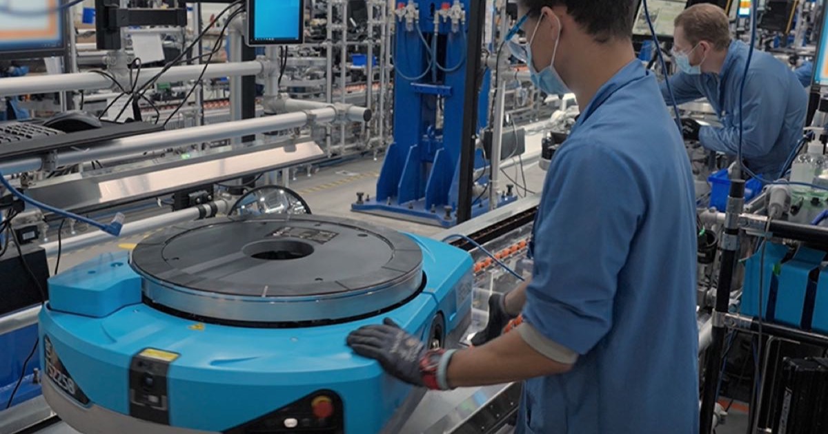 Amazon Proteus mobile robots on a warehouse floor at an Amazon fulfilment centre