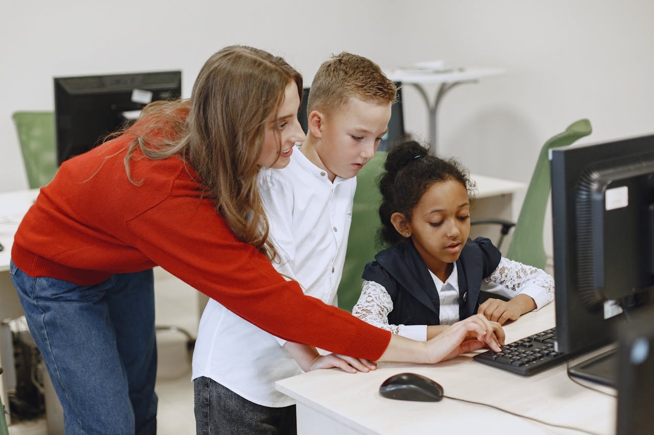 A modern school classroom with students learning at computers, bright natural lighting, educational atmosphere