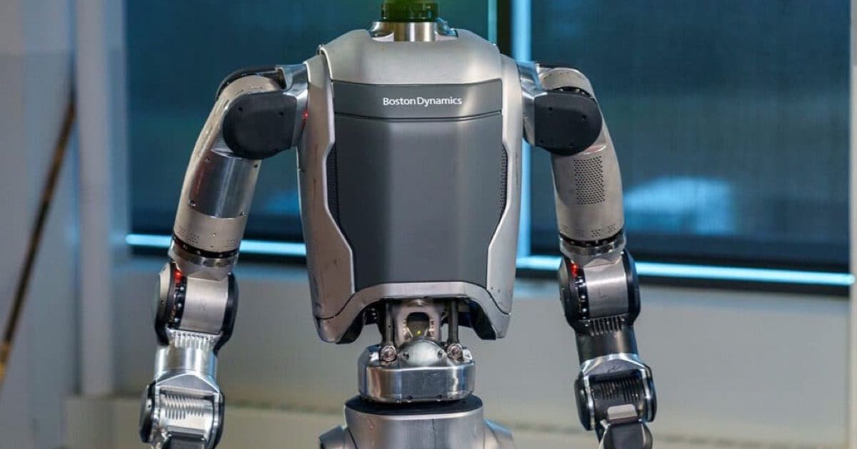 Boston Dynamics Atlas humanoid robot standing in an industrial setting, designed for continuous operation with autonomous battery swapping