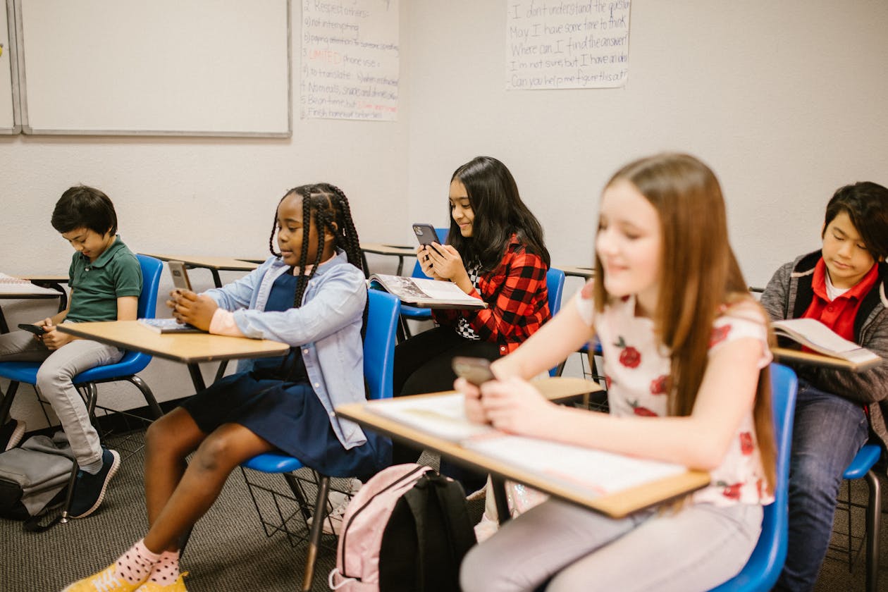 Students in a modern classroom with digital learning screens