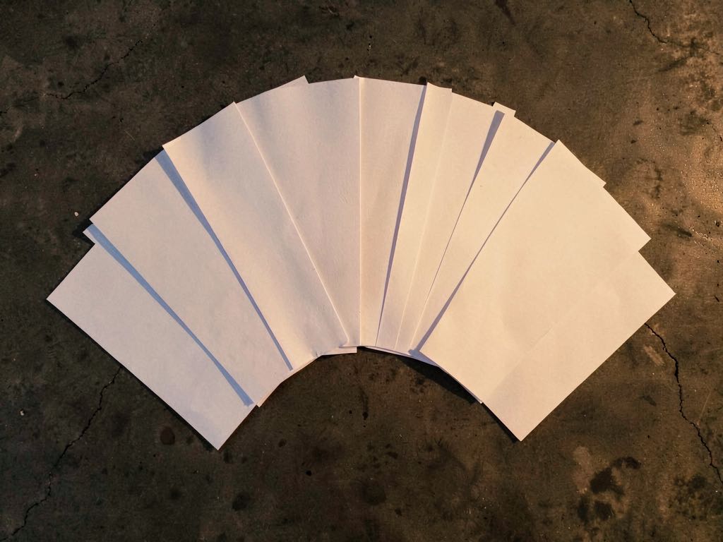 An aerial view of a stack of folded newspapers with a holographic AI network overlay, photojournalistic