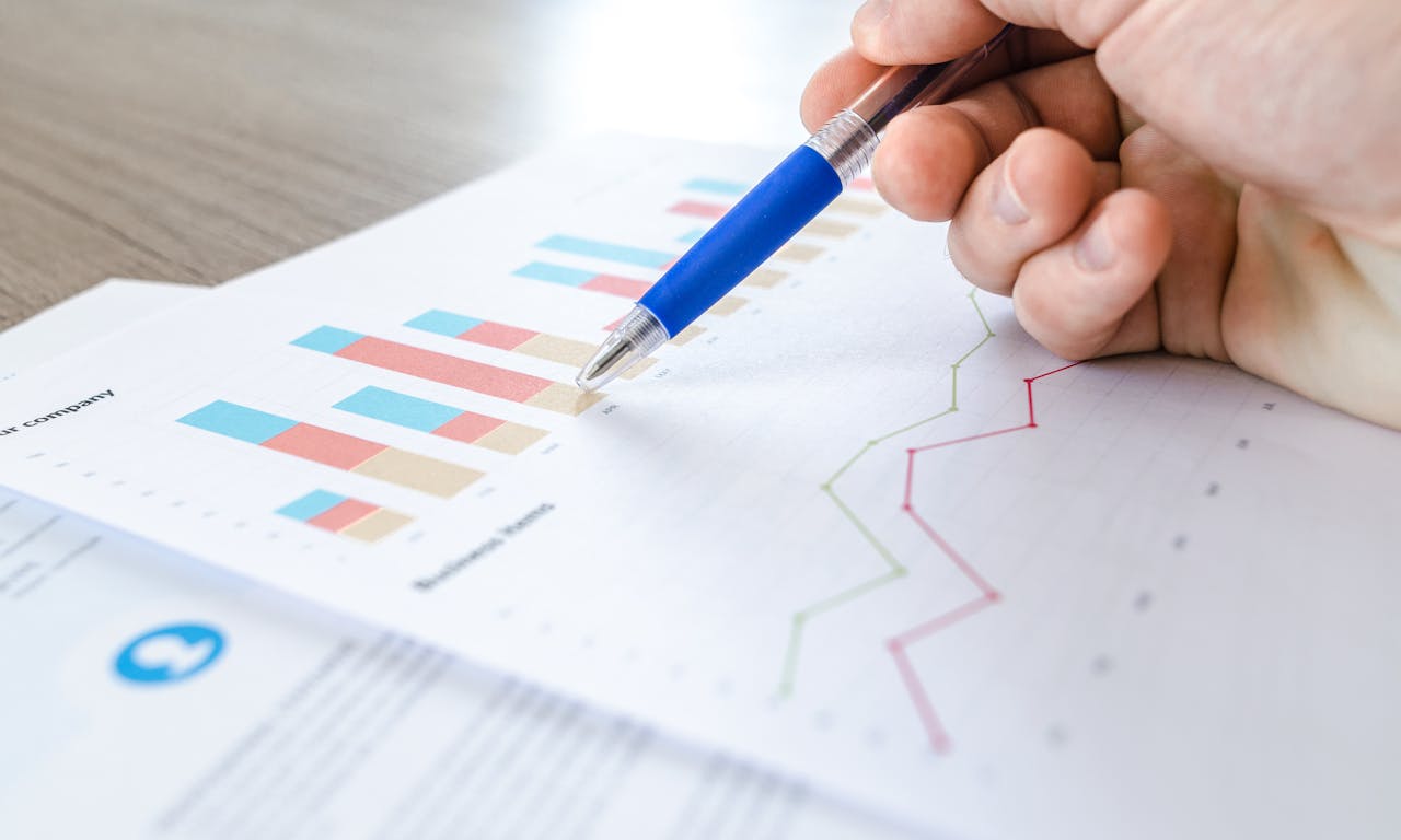A pricing chart showing a dramatic downward line against a dark blue background, data visualization style, cinematic lighting