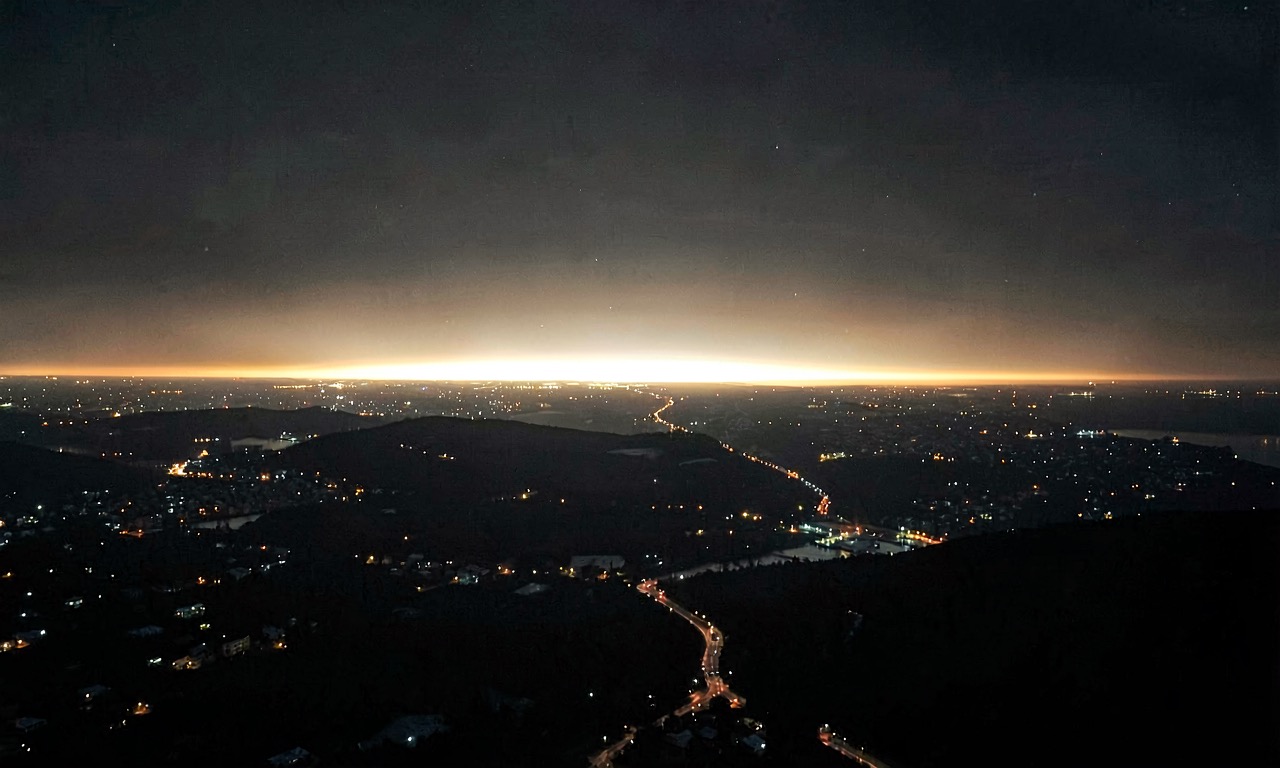 A dark atmospheric composition showing a continent of dimmed lights against a bright horizon, representing the European AI sovereignty gap.
