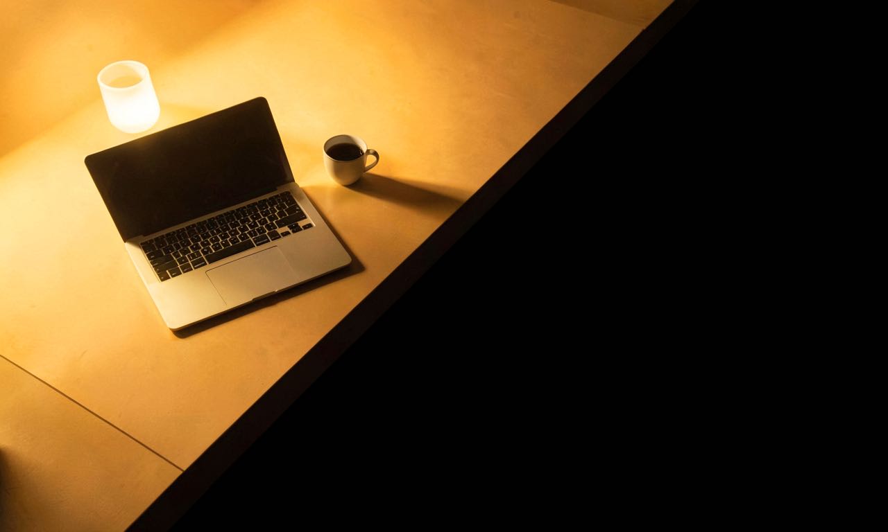 An abstract composition showing a divided workspace with one side illuminated and the other in shadow, representing the AI adoption divide.