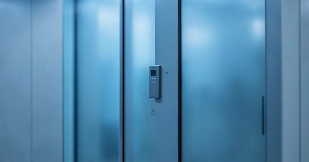 A closed server room door with an electronic access panel, cool blue lighting, editorial photography.
