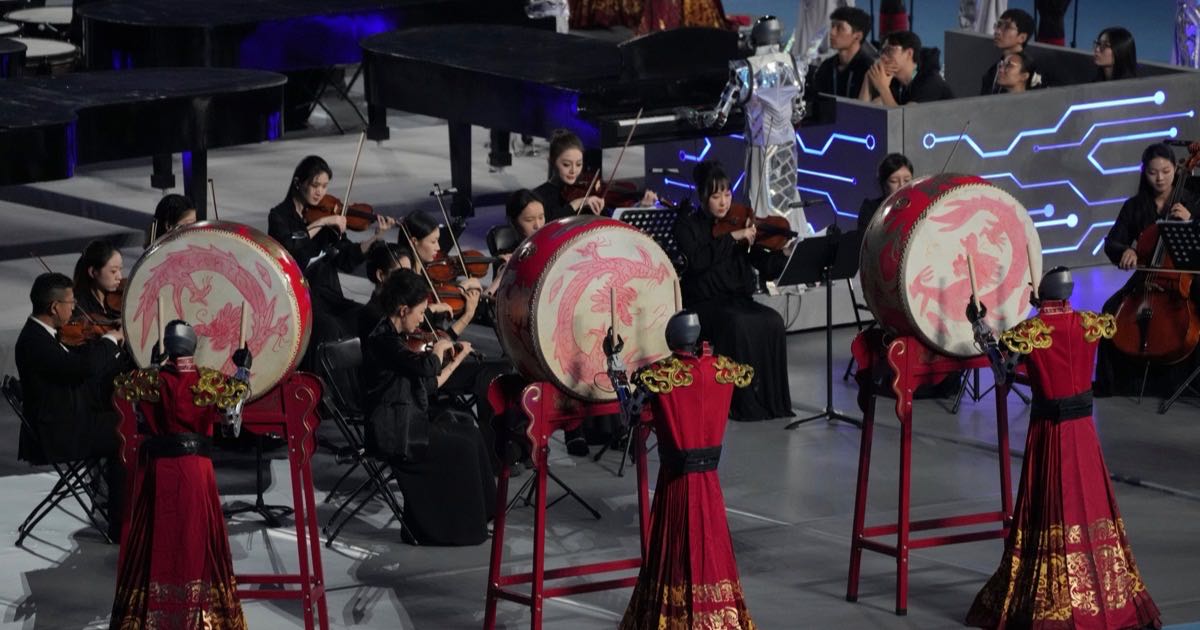 Humanoid robots perform with drums during the opening ceremony of the World Humanoid Robot Games in Beijing, August 22, 2026.