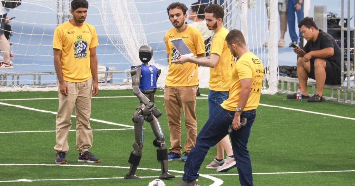 A humanoid robot undergoes testing with engineers guiding it during preparations for the 2026 World Humanoid Robot Games at the National Speed Skating Oval in Beijing.