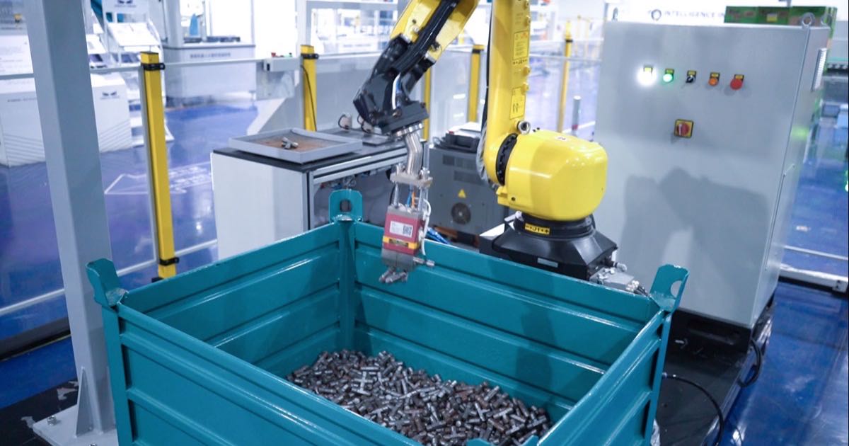 Industrial 3D vision equipment from Mech-Mind guiding a robot arm over a bin of mixed parts on an automated production line