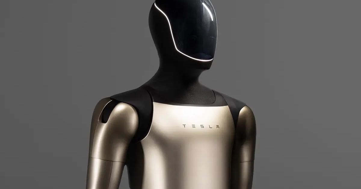 A Tesla Optimus Gen 3 humanoid robot against a plain grey studio background