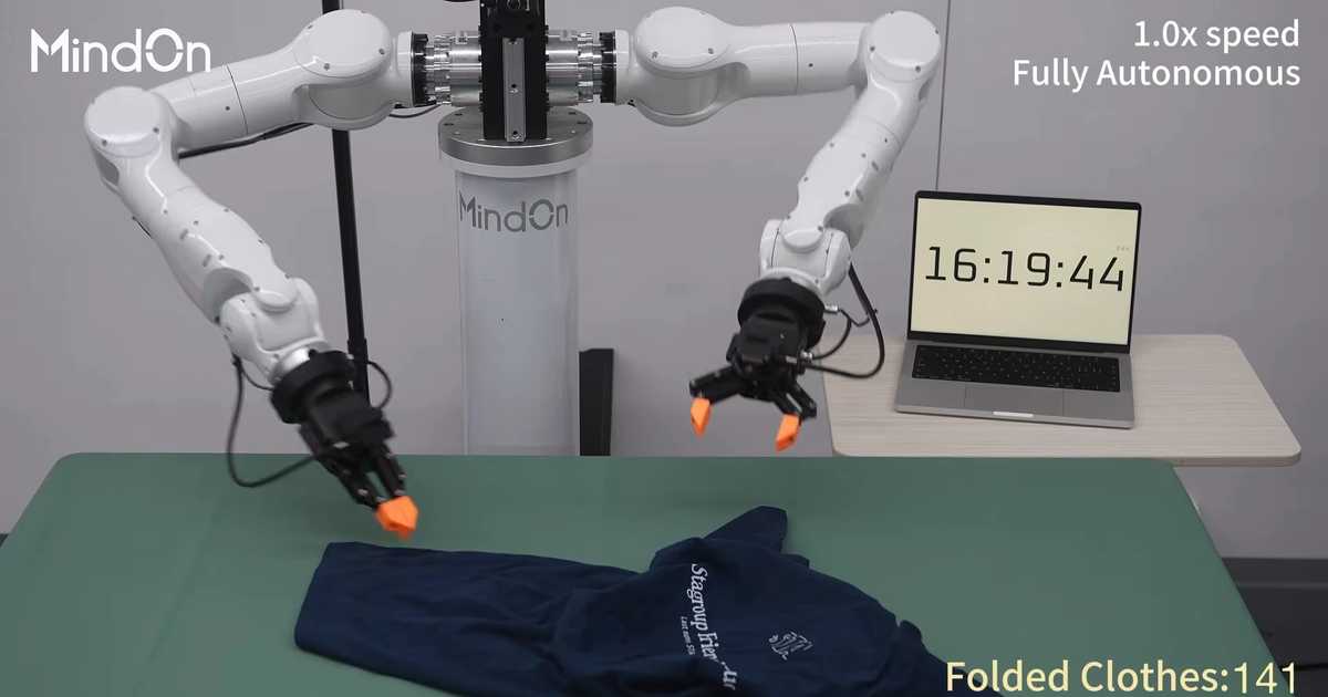 A dual-arm robot folding a dark shirt on a green work surface, with an on-screen counter reading 141, from MindOn's hour-long folding demonstration.