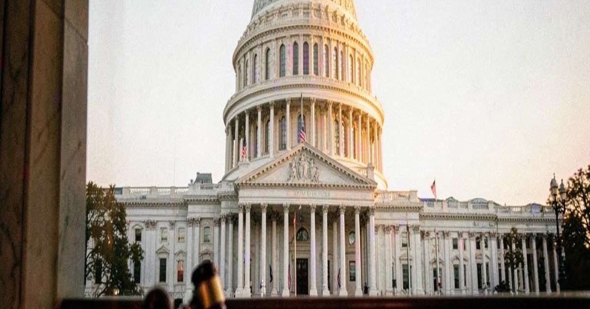 A government building with columns representing regulatory oversight, warm golden light.