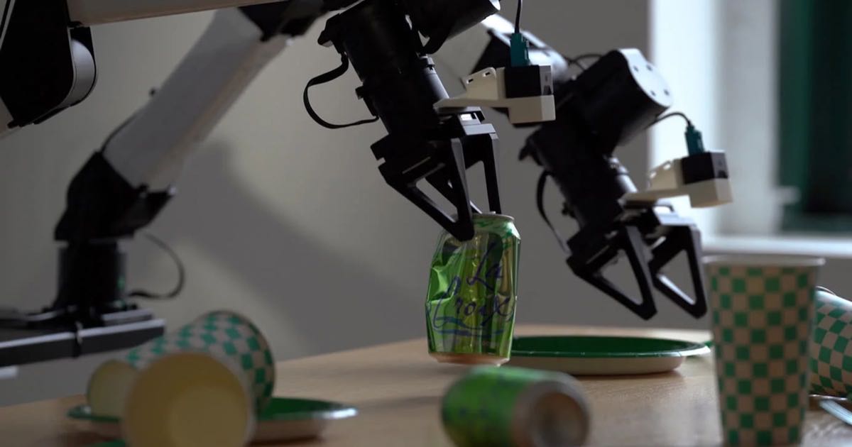 Two robot arms working over a table, one holding an empty can, during Runway's Praxis-1 testing