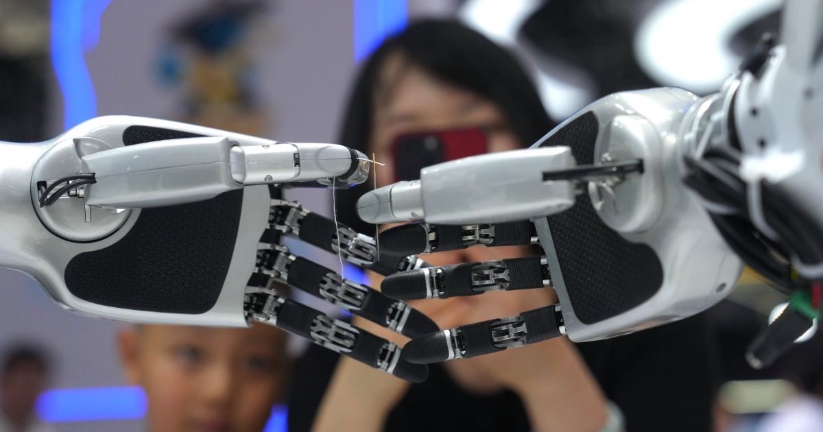A wheeled robot platform with dual robotic arms sorting packages at the World Robot Conference in Beijing, August 2026.
