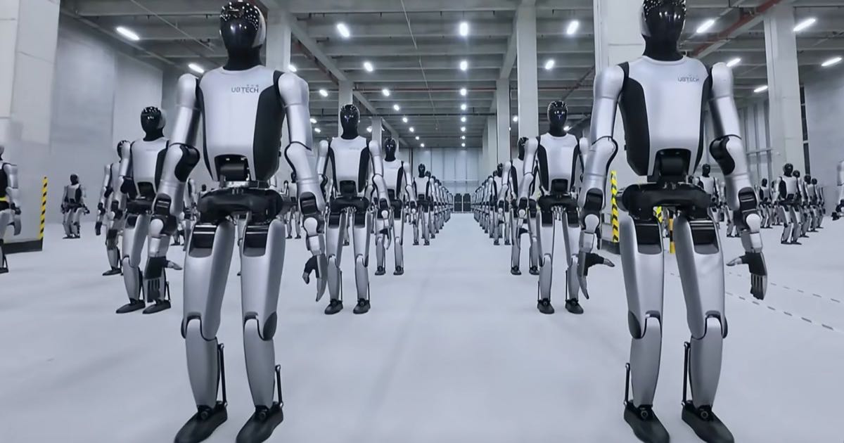 Humanoid robots competing in athletic events at a large indoor arena, with multiple robots visible on a competition floor.