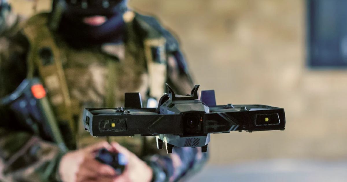 XTEND tactical micro drone in flight with an operator in the background